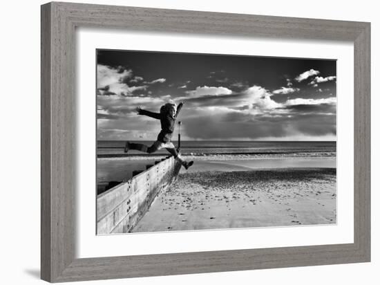 Female Figure Jumping on a Beach-Rory Garforth-Framed Photographic Print