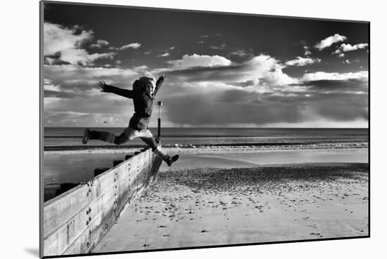 Female Figure Jumping on a Beach-Rory Garforth-Mounted Photographic Print