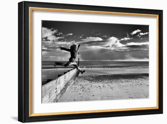 Female Figure Jumping on a Beach-Rory Garforth-Framed Photographic Print