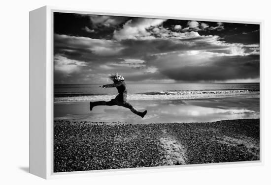 Female Figure Jumping on a Beach-Rory Garforth-Framed Premier Image Canvas