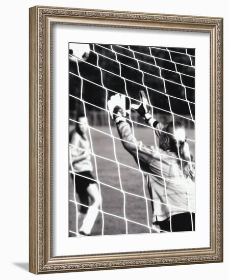 Female Goalie Attempting to Stop a Soccer Ball-null-Framed Photographic Print