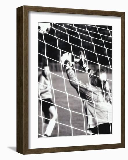 Female Goalie Attempting to Stop a Soccer Ball-null-Framed Photographic Print