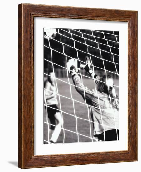 Female Goalie Attempting to Stop a Soccer Ball-null-Framed Photographic Print