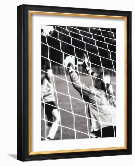 Female Goalie Attempting to Stop a Soccer Ball-null-Framed Photographic Print