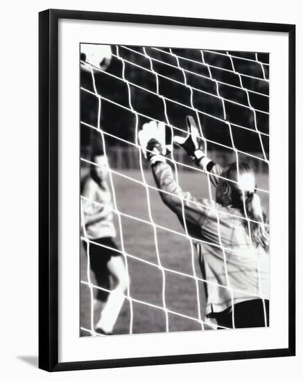 Female Goalie Attempting to Stop a Soccer Ball-null-Framed Photographic Print