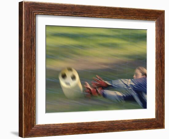 Female Goalie Attempting to Stop a Soccer Ball-null-Framed Photographic Print