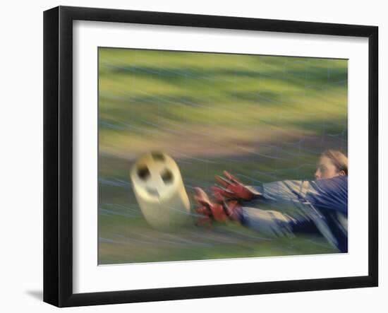 Female Goalie Attempting to Stop a Soccer Ball-null-Framed Photographic Print