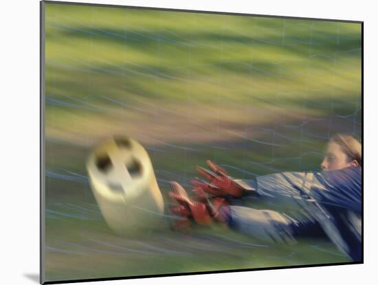 Female Goalie Attempting to Stop a Soccer Ball-null-Mounted Photographic Print