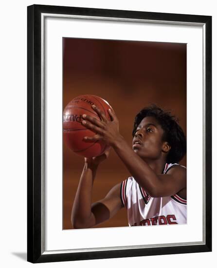 Female High Schooll Basketball Player in Action Shooting a Free Throw During a Game-null-Framed Photographic Print