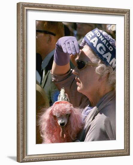 Female Holding Pink Poodle Wearing Hat Emblazoned with Reagan During Campaign Speech-Bill Ray-Framed Photographic Print