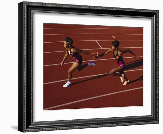 Female Runner Competing in a Relay Track Race-null-Framed Photographic Print