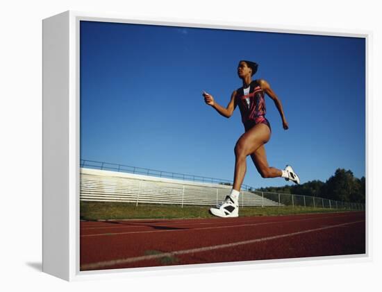 Female Runner Training on the Track-null-Framed Premier Image Canvas