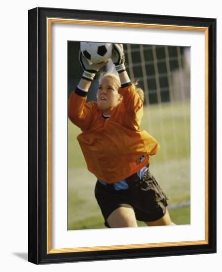 Female Soccer Goalie Catching the Ball-null-Framed Photographic Print