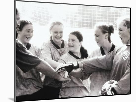 Female Soccer Team with Their Hands Together-null-Mounted Photographic Print