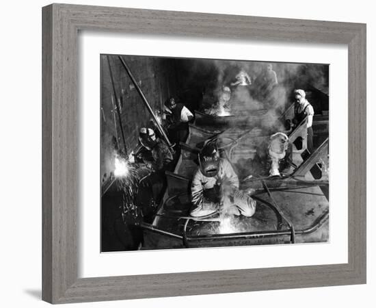 Female Welders Welding Seams on Deck Section of an Aircraft Carrier under Construction at Shipyard-Margaret Bourke-White-Framed Photographic Print