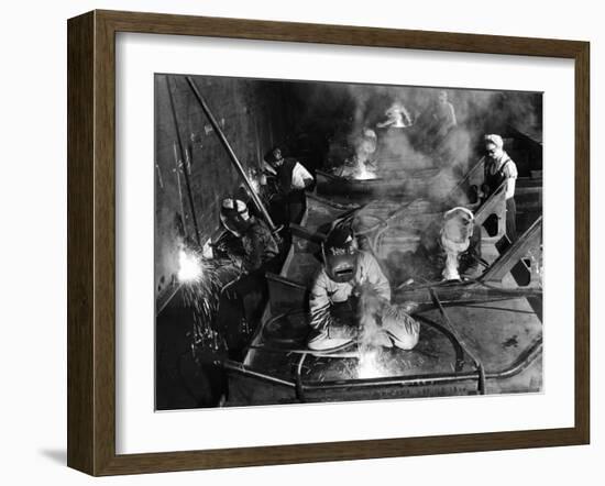 Female Welders Welding Seams on Deck Section of an Aircraft Carrier under Construction at Shipyard-Margaret Bourke-White-Framed Photographic Print