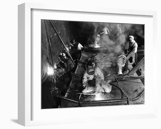 Female Welders Welding Seams on Deck Section of an Aircraft Carrier under Construction at Shipyard-Margaret Bourke-White-Framed Photographic Print