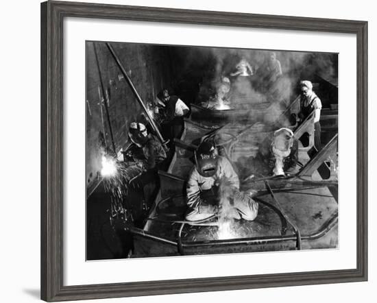 Female Welders Welding Seams on Deck Section of an Aircraft Carrier under Construction at Shipyard-Margaret Bourke-White-Framed Photographic Print