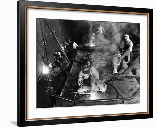 Female Welders Welding Seams on Deck Section of an Aircraft Carrier under Construction at Shipyard-Margaret Bourke-White-Framed Photographic Print