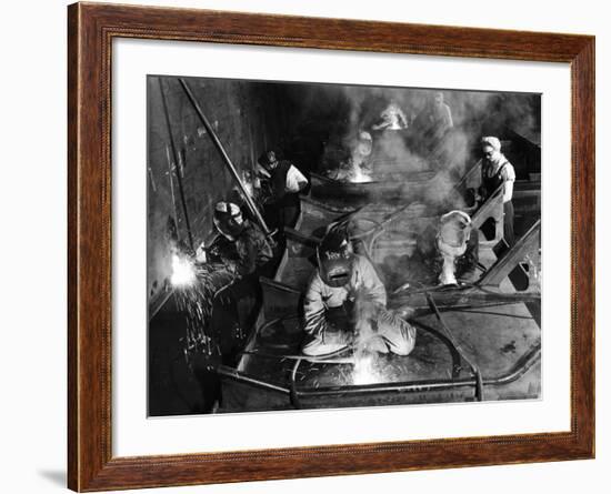 Female Welders Welding Seams on Deck Section of an Aircraft Carrier under Construction at Shipyard-Margaret Bourke-White-Framed Photographic Print