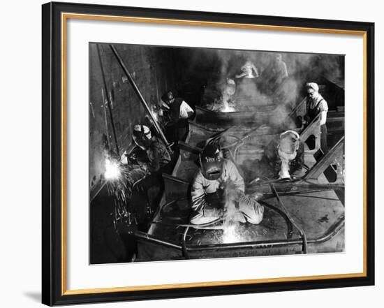Female Welders Welding Seams on Deck Section of an Aircraft Carrier under Construction at Shipyard-Margaret Bourke-White-Framed Photographic Print