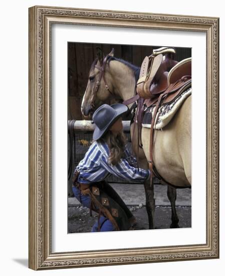Female Wrangler Saddles Horse at Boulder River Ranch, Montana, USA-Jamie & Judy Wild-Framed Photographic Print