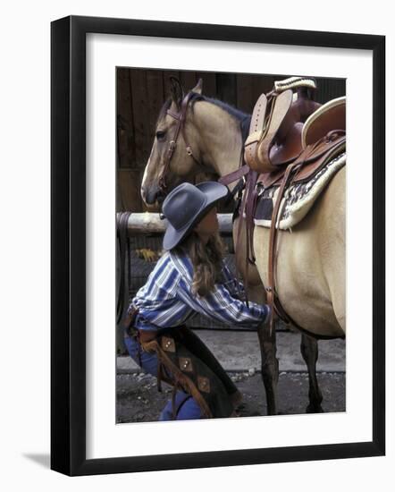 Female Wrangler Saddles Horse at Boulder River Ranch, Montana, USA-Jamie & Judy Wild-Framed Photographic Print