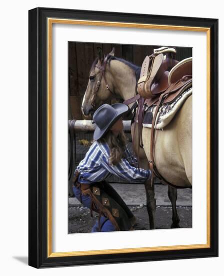 Female Wrangler Saddles Horse at Boulder River Ranch, Montana, USA-Jamie & Judy Wild-Framed Photographic Print