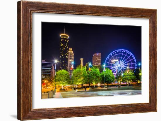 Ferris Wheel and Buildings Seen from Olympic Centennial Park at Night in Atlanta, Georgia.-Jon Bilous-Framed Photographic Print