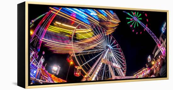 Ferris Wheel and various other funfair rides at night at Nottingham's Goose Fair, Nottingham, Notti-Frank Fell-Framed Premier Image Canvas