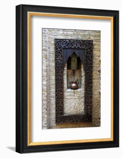 Fes, Morocco. Old copper pot sits on a ledge with a carved wooden frame.-Julien McRoberts-Framed Photographic Print