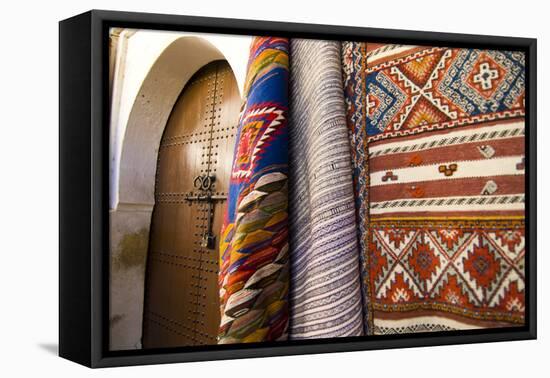 Fez Morocco decorative door and hanging patterned carpets in the old medina-Ellen Clark-Framed Premier Image Canvas