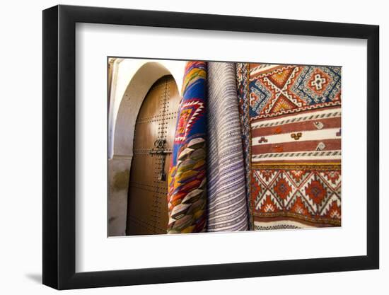 Fez Morocco decorative door and hanging patterned carpets in the old medina-Ellen Clark-Framed Photographic Print