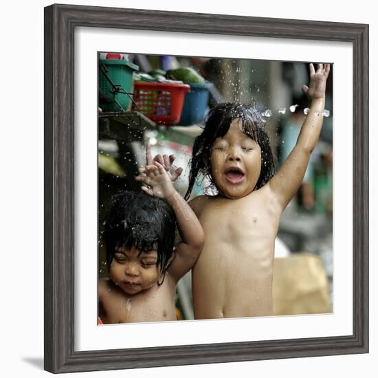 Filipino Children React as They Get a Shower Outside Their Homes-null-Framed Photographic Print