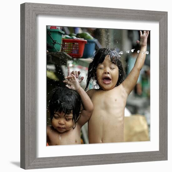 Filipino Children React as They Get a Shower Outside Their Homes-null-Framed Photographic Print