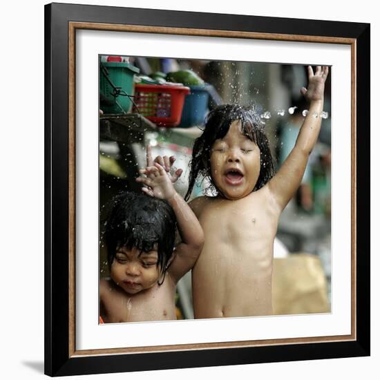 Filipino Children React as They Get a Shower Outside Their Homes-null-Framed Photographic Print