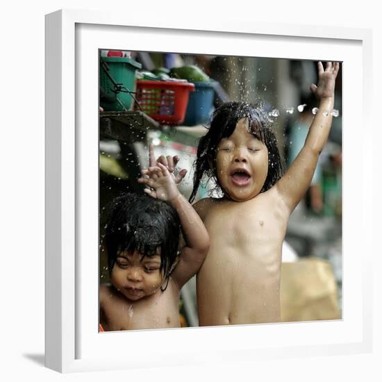 Filipino Children React as They Get a Shower Outside Their Homes-null-Framed Photographic Print