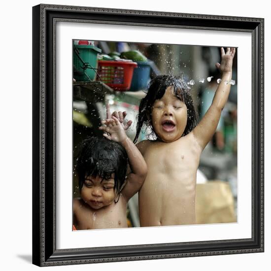 Filipino Children React as They Get a Shower Outside Their Homes-null-Framed Photographic Print