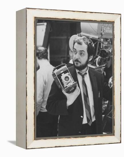 Film Director Stanley Kubrick Holding Polaroid Camera During Filming of "2001: A Space Odyssey"-Dmitri Kessel-Framed Premier Image Canvas