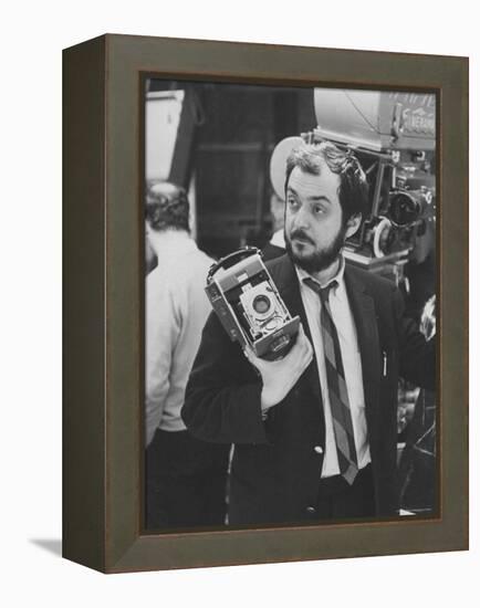 Film Director Stanley Kubrick Holding Polaroid Camera During Filming of "2001: A Space Odyssey"-Dmitri Kessel-Framed Premier Image Canvas