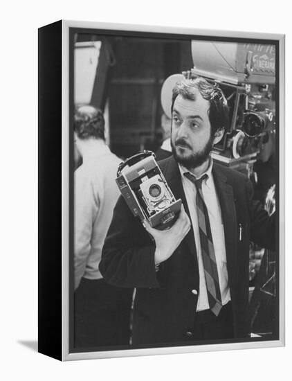 Film Director Stanley Kubrick Holding Polaroid Camera During Filming of "2001: A Space Odyssey"-Dmitri Kessel-Framed Premier Image Canvas