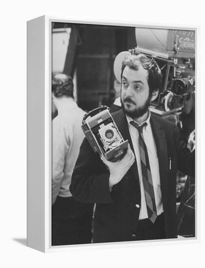 Film Director Stanley Kubrick Holding Polaroid Camera During Filming of "2001: A Space Odyssey"-Dmitri Kessel-Framed Premier Image Canvas