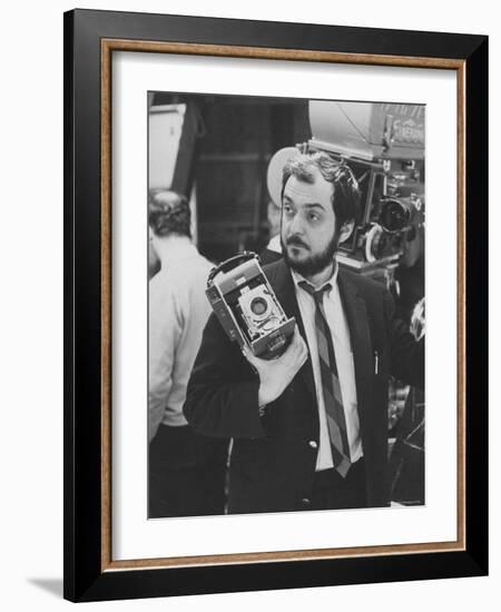 Film Director Stanley Kubrick Holding Polaroid Camera During Filming of "2001: A Space Odyssey"-Dmitri Kessel-Framed Premium Photographic Print