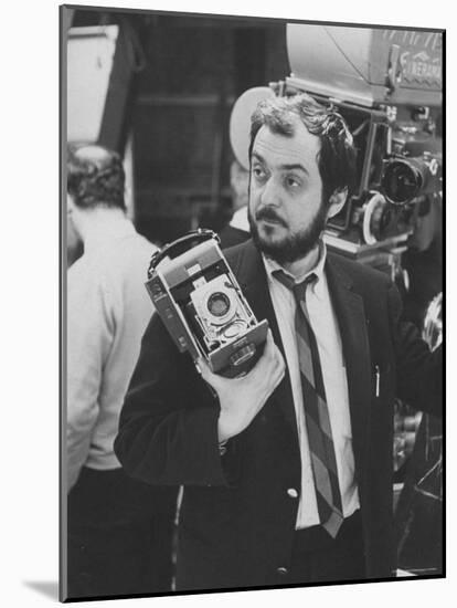 Film Director Stanley Kubrick Holding Polaroid Camera During Filming of "2001: A Space Odyssey"-Dmitri Kessel-Mounted Premium Photographic Print