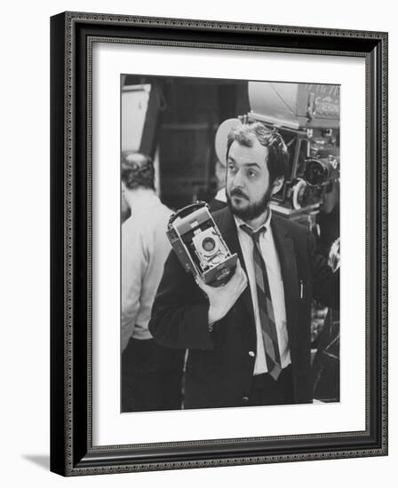 Film Director Stanley Kubrick Holding Polaroid Camera During Filming of "2001: A Space Odyssey"-Dmitri Kessel-Framed Premium Photographic Print