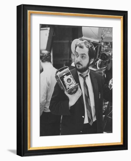 Film Director Stanley Kubrick Holding Polaroid Camera During Filming of "2001: A Space Odyssey"-Dmitri Kessel-Framed Premium Photographic Print