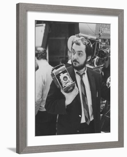 Film Director Stanley Kubrick Holding Polaroid Camera During Filming of "2001: A Space Odyssey"-Dmitri Kessel-Framed Premium Photographic Print