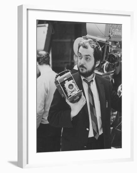 Film Director Stanley Kubrick Holding Polaroid Camera During Filming of "2001: A Space Odyssey"-Dmitri Kessel-Framed Premium Photographic Print