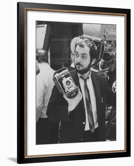 Film Director Stanley Kubrick Holding Polaroid Camera During Filming of "2001: A Space Odyssey"-Dmitri Kessel-Framed Premium Photographic Print