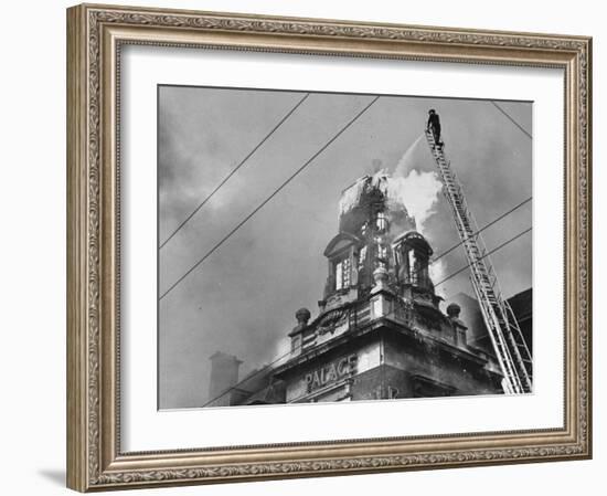 Fireman on Ladder Using a Hose to Extinguish Blazing Building Set Afire-Hans Wild-Framed Photographic Print